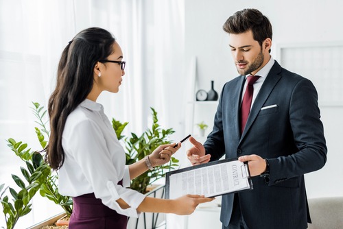 Two professionals reviewing a contract together.