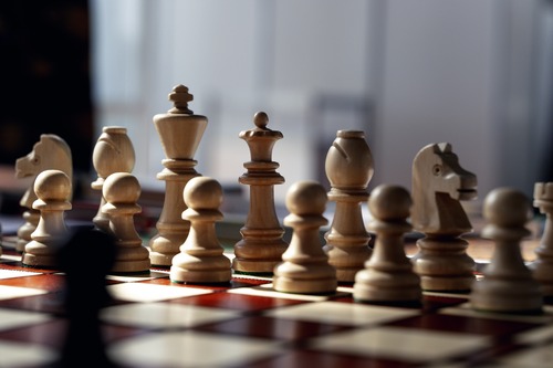 Chess pieces arranged on a chessboard.