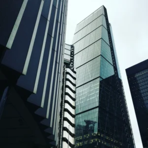 Modern glass high-rise buildings viewed from street level.